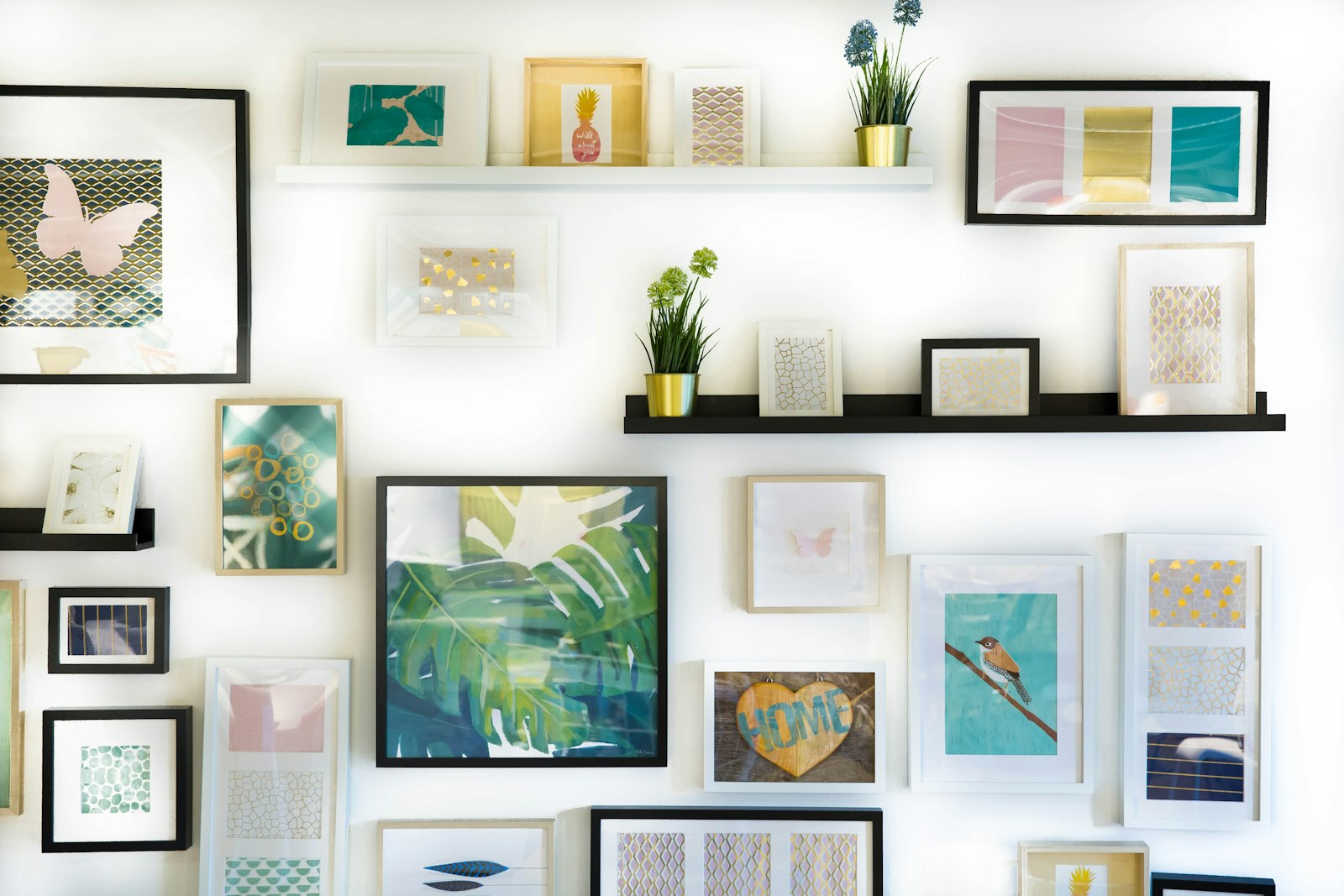 Assorted framed paintings on a gallery wall