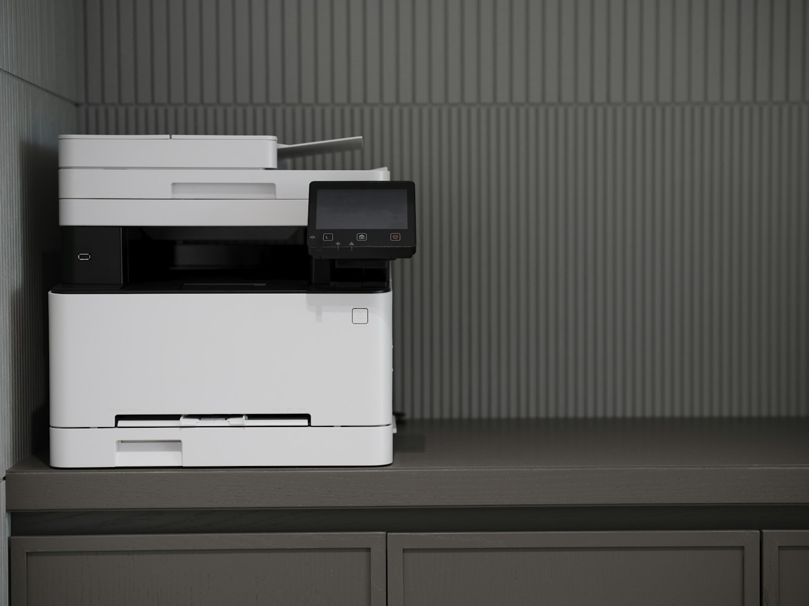 White and black home printer on a counter