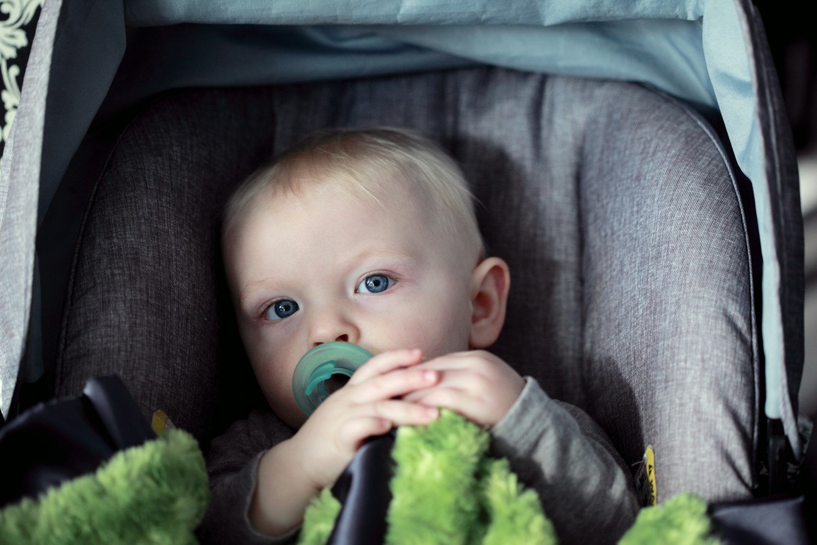 Baby in a gray stroller